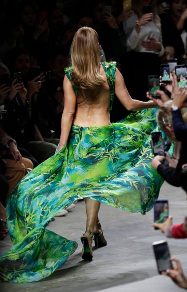 AP19263705240514 Actress Jennifer Lopez wears a creation as part of the Versace Spring-Summer 2020 collection, unveiled during the fashion week, in Milan, Italy, Friday, Sept. 20, 2019. (AP Photo/Luca Bruno)