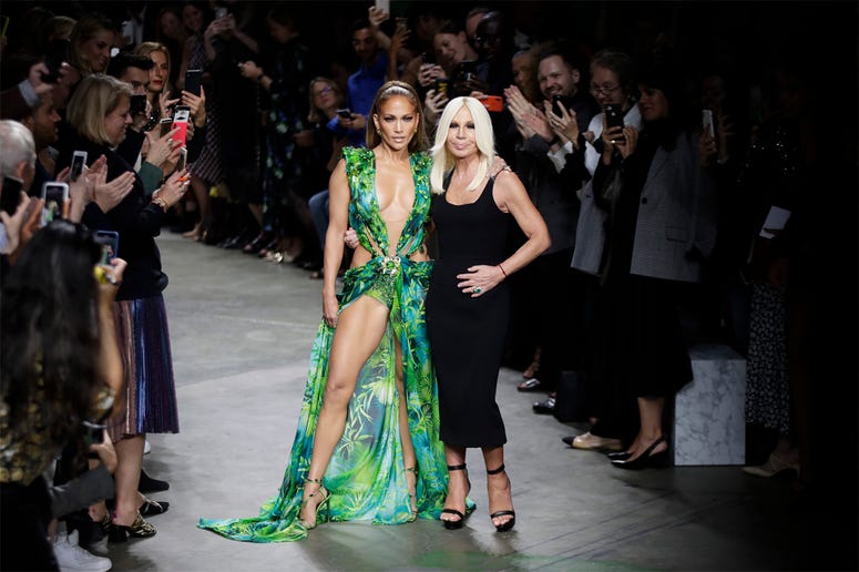 AP19263705605466 Actress Jennifer Lopez, left, and designer Donatella Versace accept applause at the conclusion of the Versace Spring-Summer 2020 collection, unveiled during the fashion week, in Milan, Italy, Friday, Sept. 20, 2019. (AP Photo/Luca Bruno)