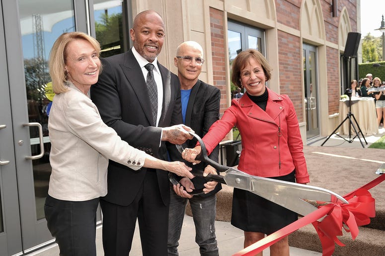AP19275738416362 University of Southern California Dean Erica Muhl, from left, Andre "Dr. Dre" Young, Jimmy Iovine and USC President Carol Folt participate in the unveiling of a high-tech building named after Young and Iovine on the University of Southern California campu