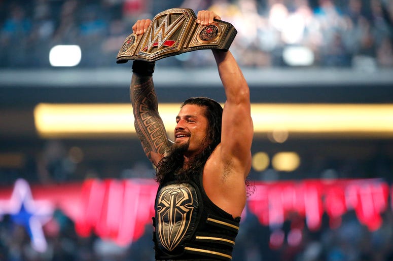 AP19276499518285 In this April 3, 2016, file photo, Roman Reigns holds up the championship belt after defeating Triple H during WrestleMania 32 at AT&T Stadium in Arlington, Texas. (Jae S. Lee/The Dallas Morning News via AP, File)/The Dallas Morning News via AP)