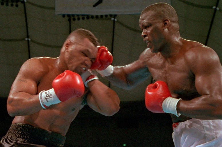 AP19302645155228 In this Feb. 11, 1990, file photo, James "Buster" Douglas, right, hits Mike Tyson with a hard right in the face during their world heavyweight title bout at the Tokyo Dome in Tokyo. (AP Photo/Sadayuki Mikami, File)