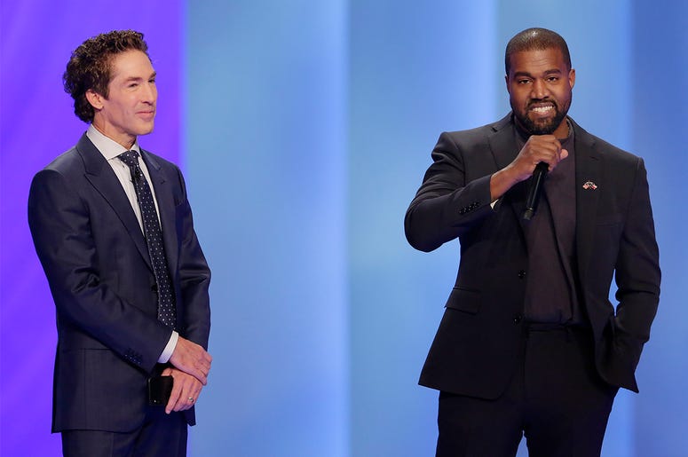 AP19321725030137 Rapper Kanye West, right, answers questions from Joel Osteen, left, during a service at Lakewood Church, Sunday, Nov. 17, 2019, in Houston. (AP Photo/Michael Wyke)