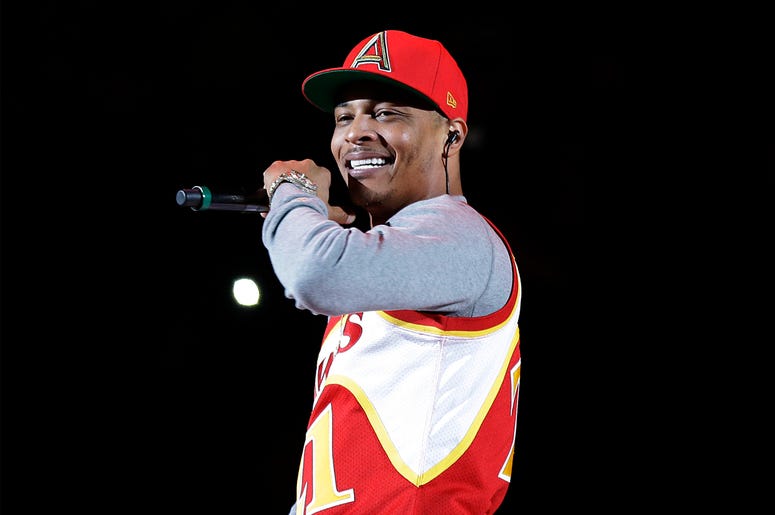 AP19338567060907 In this Nov. 1, 2014, file photo, rapper T.I. performs before the start of an NBA basketball game between the Indiana Pacers and the Atlanta Hawks in Atlanta. (AP Photo/David Goldman, File)