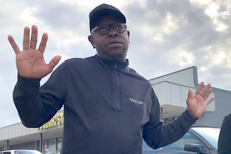AP19346754978964 In this Tuesday, Dec. 10, 2019, Rapper turned political candidate, Brad "Scarface" Jordan, left, visits with voter Michele Lemon and her son outside of an early voting location in the Sunnyside neighborhood of Houston, Texas. Jordan is in a run-off agains
