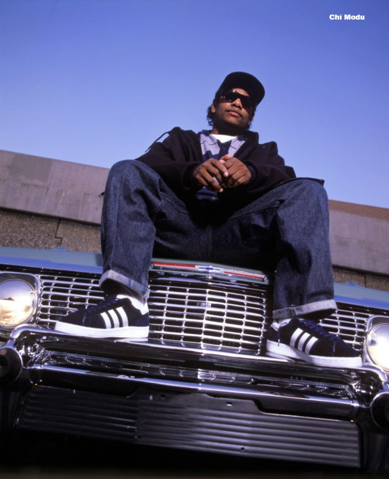 Eazy-ECompton, California (1994) Eazy E (Eric Wight) sitting on the hood of his car in Compton, CA in 1994, one year before his untimely death. This photo is from the Defining Years of Hip-Hop 1990-2000 (Photo by Chi Modu/diverseimages)
