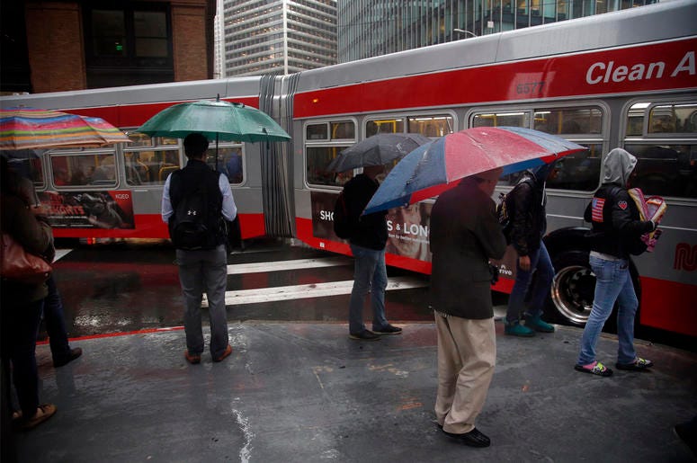 (Photo credit: Karl Mondon/Bay Area News Group/TNS) Bus riders and pedestrians brave the storm with rain pouring down in the Financial District of San Francisco on Friday, Oct. 14, 2016. (Photo by Karl Mondon/Bay Area News Group/TNS)