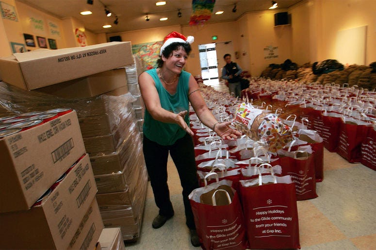 GLIDE volunteer SAN FRANCISCO - DECEMBER 16: A volunteer tosses a loaf of bread that will be put into grocery bags to be distributed to the needy at Glide Memorial Church December 16, 2004 in San Francisco. The church hopes to pass out 8,000 grocery bags to people in nee