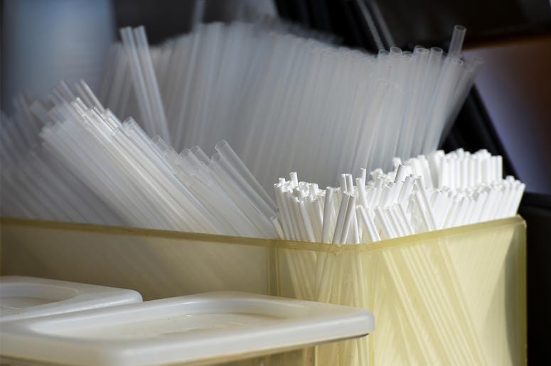 Straws in a plastic container Straws in a plastic container