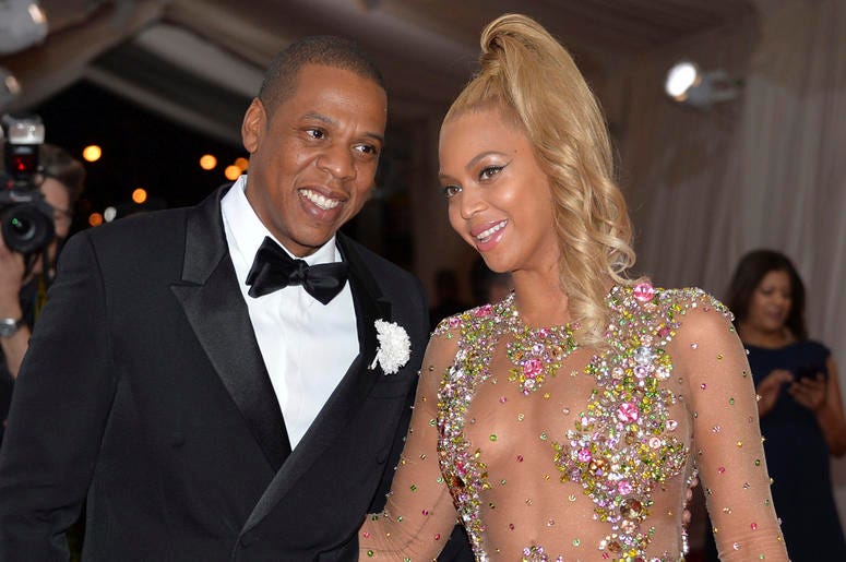 AP18215283137115 In this May 4, 2015, file photo, Jay Z, left, and Beyonce arrive at The Metropolitan Museum of Art's Costume Institute benefit gala celebrating "China: Through the Looking Glass" in New York. After bad weather forced concertgoers at the MetLife Stadium in