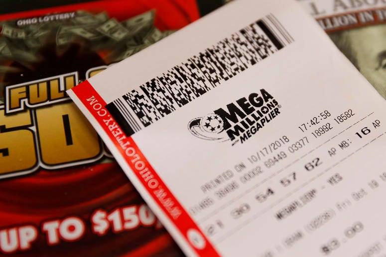 AP18290796556377 A Mega Millions lottery ticket rests on the shop counter at the Street Corner Market, Wednesday, Oct. 17, 2018, in Cincinnati. The estimated jackpot for Friday's drawing would be the second-largest lottery prize in U.S. history with a jackpot estimated to