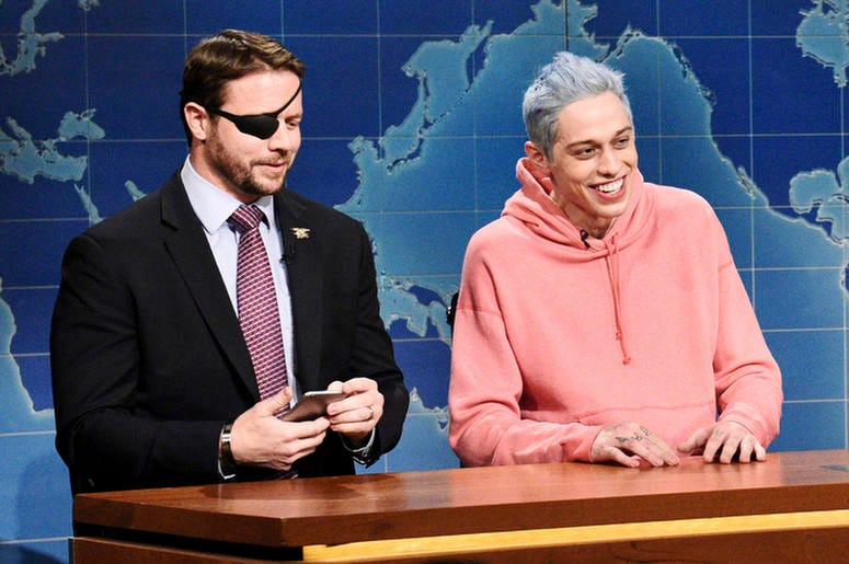 AP18315564956090 In this Nov. 10, 2018 photo provided by NBC, Lt. Com. Dan Crenshaw, from left, a congressman-elect from Texas and Pete Davidson appear during Saturday Night Live’s "Weekend Update" in New York. Davidson made his apologies to Crenshaw whose appearance he m