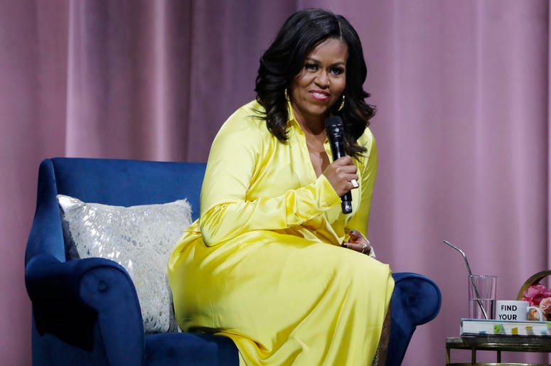 AP18354083595350 Former first lady Michelle Obama responds to questions as she is interviewed by actress Sarah Jessica Parker during an appearance for her book, "Becoming: An Intimate Conversation with Michelle Obama" at Barclays Center Wednesday, Dec. 19, 2018, in New Yo