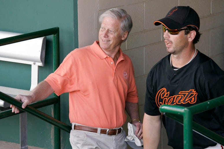 AP19028075244672 This March 1, 2008, file photo shows San Francisco Giants managing general partner Peter Magowan, left, visiting with center fielder Aaron Rowand, right, in the dugout prior to their spring training baseball game against the Oakland Athletics in Scottsdal
