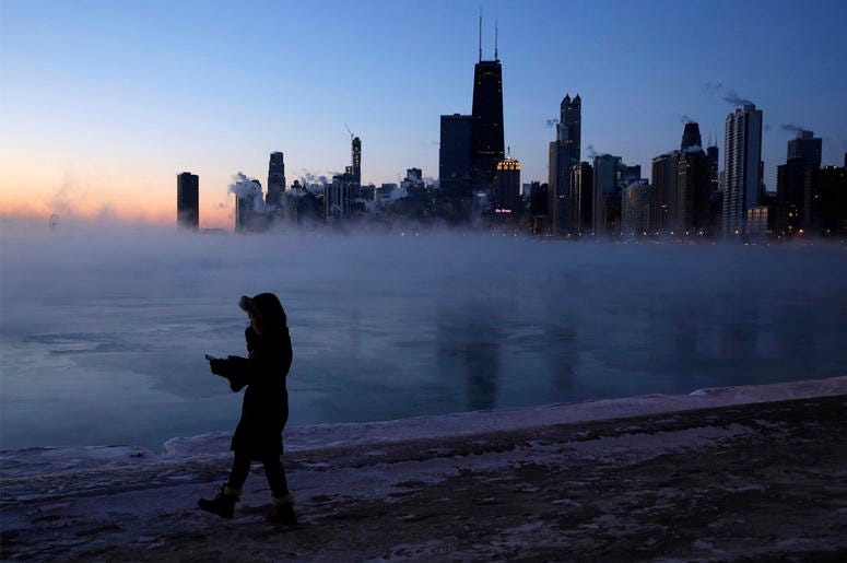 AP19030538683051 A person walks along the lakeshore, Wednesday, Jan. 30, 2019, in Chicago. A deadly arctic deep freeze enveloped the Midwest with record-breaking temperatures on Wednesday, triggering widespread closures of schools and businesses, and prompting the U.S. Po