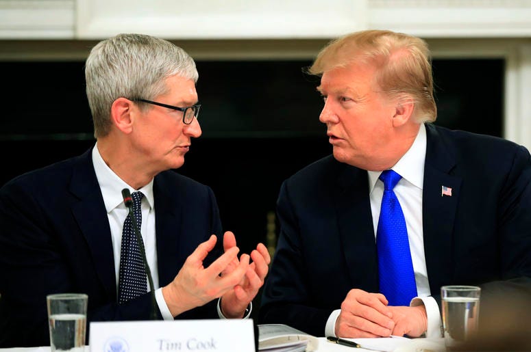 AP19066789722766 In this Wednesday, March 6, 2019 file photo, President Donald Trump talks to Apple Inc. CEO Tim Cook during the American Workforce Policy Advisory Board's first meeting in the State Dining Room of the White House in Washington. (AP Photo/Manuel Balce Cene