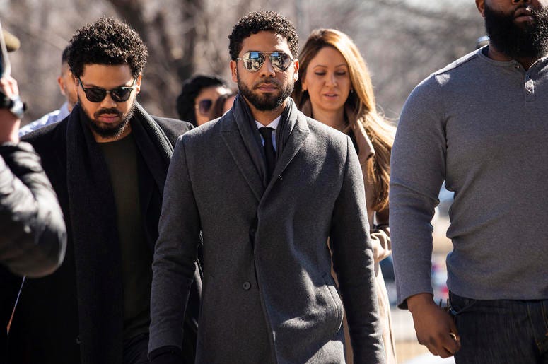AP19071587816568 "Empire" actor Jussie Smollett, center, arrives at Leighton Criminal Court Building for a hearing to discuss whether cameras will be allowed in the courtroom during his disorderly conduct case on Tuesday, March 12, 2019, in Chicago. (Ashlee Rezin/Chicago