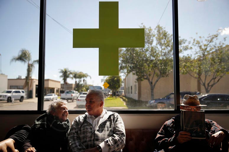 AP19075024690566 In this Feb. 19, 2019 photo, Kay Nelson, left, and Bryan Grode, retried seniors from Laguna Woods Village, chat in the lobby of Bud and Bloom cannabis dispensary while waiting for a free shuttle to arrive in Santa Ana, Calif. (AP Photo/Jae C. Hong)