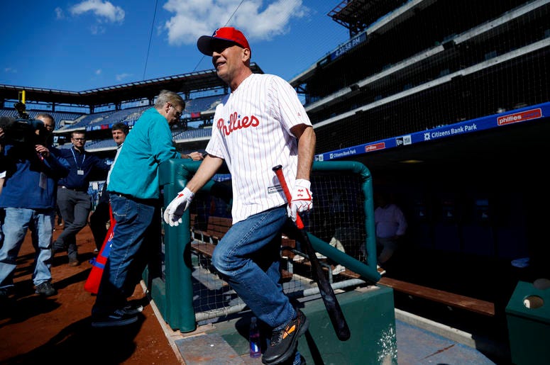 AP19135760088436 Actor Bruce Willis walks out of the Philadelphia Phillies' dugout to take batting practice before a baseball game against the Milwaukee Brewers, Wednesday, May 15, 2019, in Philadelphia. (AP Photo/Matt Slocum)