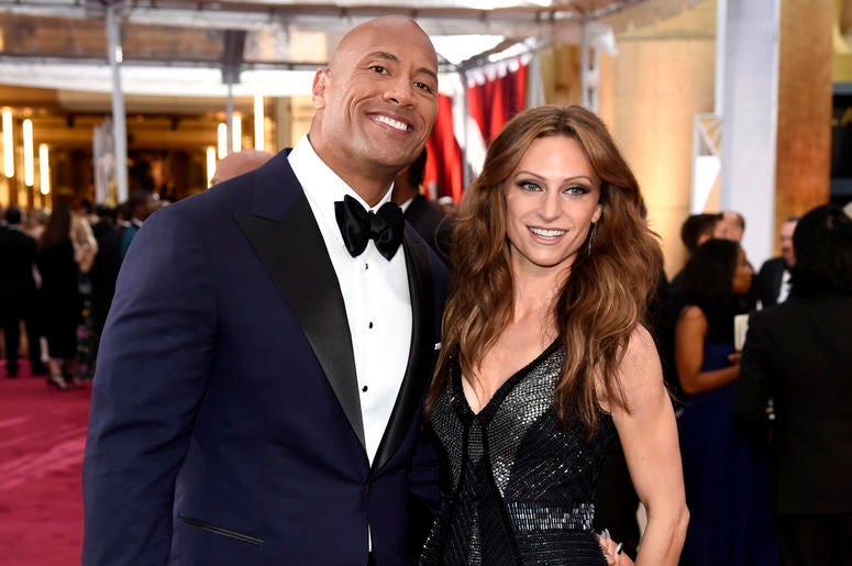 AP19231512499382 In this Feb. 22, 2015, file photo Dwayne Johnson, left, and Lauren Hashian arrive at the Oscars at the Dolby Theatre in Los Angeles.