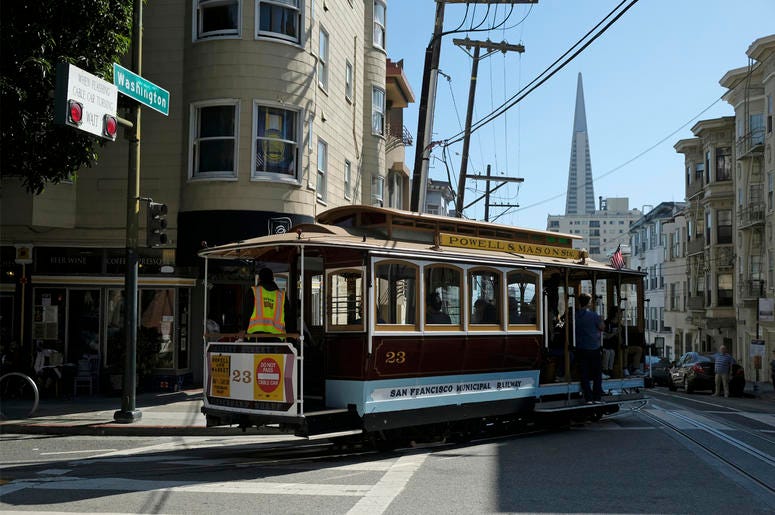 AP19254687538187 A cable car turns onto Washington Street with the Transamerica Pyramid in the background Wednesday, Sept. 11, 2019, in San Francisco. (AP Photo/Eric Risberg)