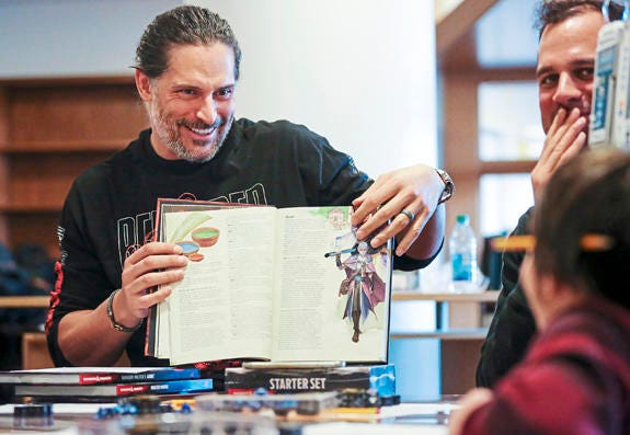 AP19009154172620 Actor and Mt. Lebanon, Pa. native Joe Manganiello, left, reads the Dungeons and Dragons character options to brother Nick Manganiello, top right, and UPMC Children's Hospital patient and first time D&D player Gabriel Bowers, 9, of Shaler, Pa., right, at U