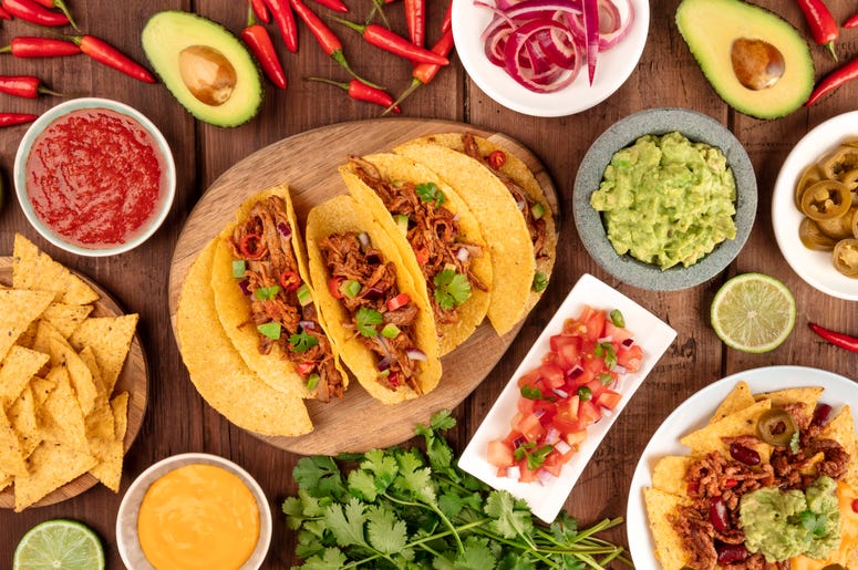 A plate of tacos and condiments
