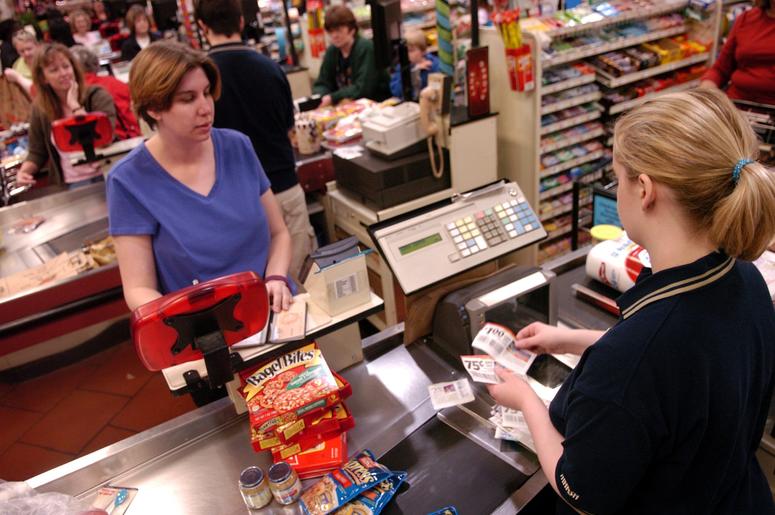 Cashier Erin Travis scans coupons from Heather Sokol at a Marsh Supermarket in Westfield, Indiana, on triple coupon day at the store Cashier checkout