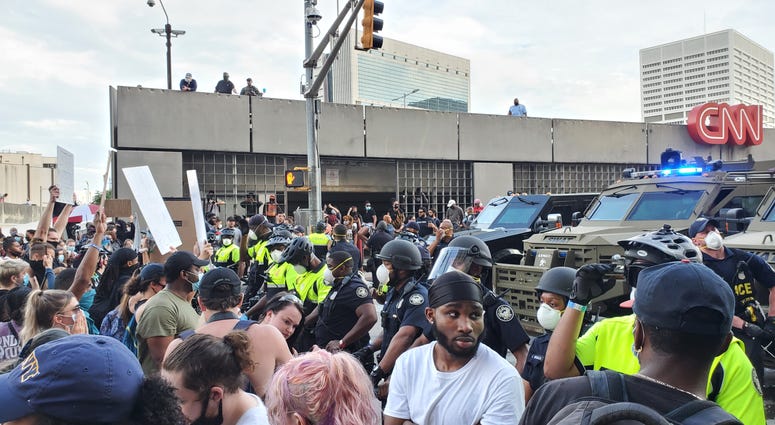 Military-type SWAT vehicles are position during protest outside CNN Center in Atlanta Friday Military-type SWAT vehicles are positioned during protest outside CNN Center in Atlanta Friday
