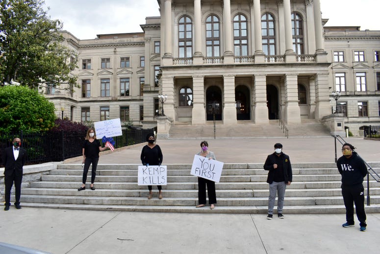 Protesters participate in mock funeral outside GA State Capitol as the stay at home order is scheduled to expire at 11:59pm Protesters participate in mock funeral outside GA State Capitol as the stay at home order is scheduled to expire at 11:59pm