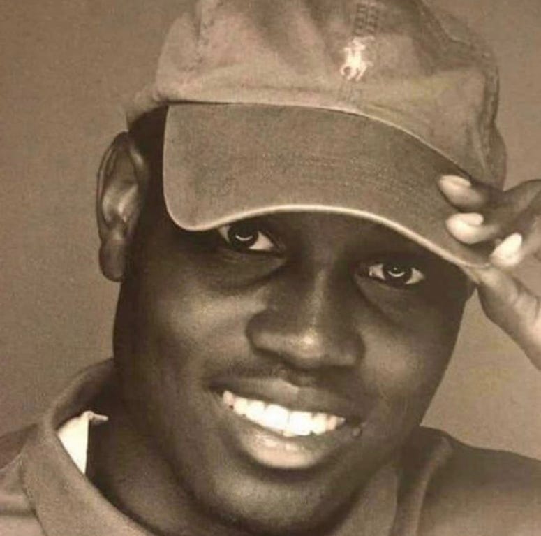 A photo of Ahmaud Arbery indicates that he is a dark-skinned black man A photo of Ahmaud Arbery indicates that he is a dark-skinned black man