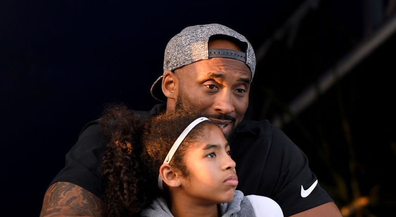 IRVINE, CA - JULY 26: Kobe Bryant and daughter Gianna Bryant watch during day 2 of the Phillips 66 National Swimming Championships at the Woollett Aquatics Center on July 26, 2018 in Irvine, California. (Photo by Harry How/Getty Images) GettyImages-1005861744.jpg