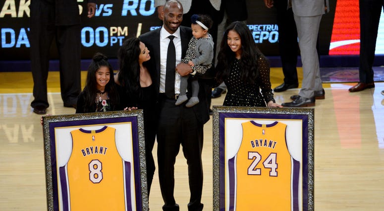 LOS ANGELES, CA - DECEMBER 18: Kobe Bryant poses with his family at halftime after both his #8 and #24 Los Angeles Lakers jerseys are retired at Staples Center on December 18, 2017 in Los Angeles, California. NOTE TO USER: User expressly acknowledges and GettyImages-895547614.jpg