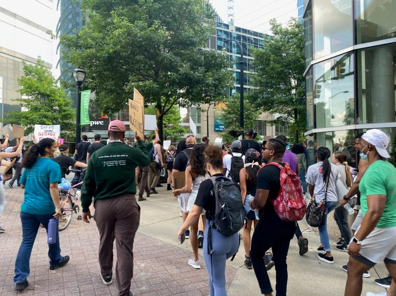 Protesters chanted "Black Lives Matter Too" as they walked down Peachtree Street in Atlanta Tuesday. Protesters chanted "Black Lives Matter Too" as they walked down Peachtree Street in Atlanta Tuesday.