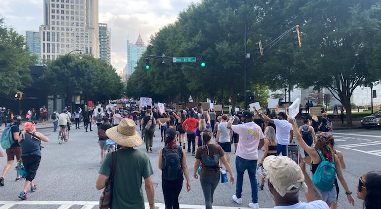 Protesters chanted "Black Lives Matter Too" as they walked down Peachtree Street in Atlanta Tuesday. Protesters chanted "Black Lives Matter Too" as they walked down Peachtree Street in Atlanta Tuesday.