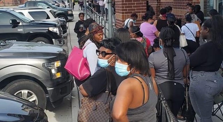 A long line extends outside the Ross store in McDonough GA as customers await their turn to enter A long line extends outside the Ross store in McDonough GA as customers await their turn to enter