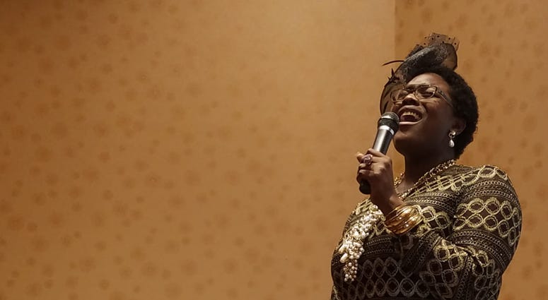 Mrs. Juanita Abernathy is serenaded by Nia Sade' Akinyemi during a recent NAACP awards event Mrs. Juanita Abernathy is serenaded by Nia Sade' Akinyemi during a recent NAACP awards event