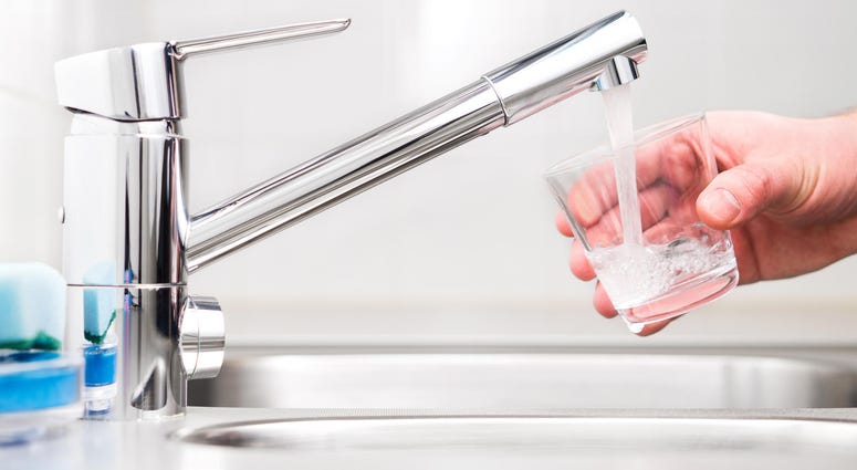 Filling glass with tap water. Modern faucet and sink. Filling glass with tap water. Modern faucet and sink.