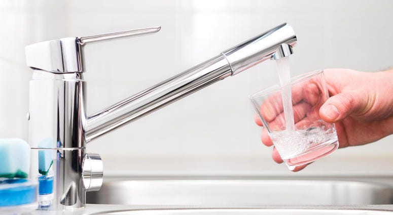 Filling glass with tap water. Modern faucet and sink. Filling glass with tap water. Modern faucet and sink.