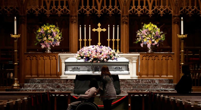 Mourners pause as former U.S. first lady Barbara Bush lies in repose during the visitation of former first lady Barbara Bush at St. Martin's Episcopal Church, Friday, April 20, 2018, in Houston. Barbara Bush