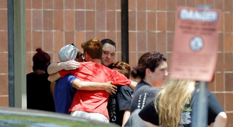 People react outside the unification center at the Alamo Gym, following a shooting at Santa Fe High School Friday, May 18, 2018, in Santa Fe, Texas. People react outside the unification center at the Alamo Gym, following a shooting at Santa Fe High School Friday, May 18, 2018, in Santa Fe, Texas.