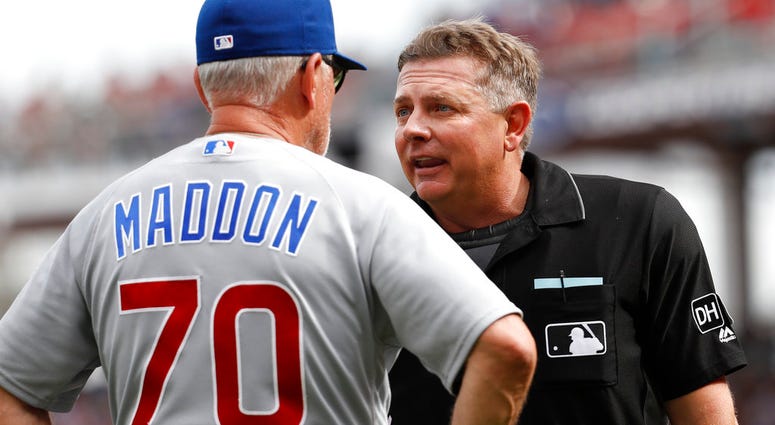 Umpire Greg Gibson, right, argues with Chicago Cubs manager Joe Maddon (70) after throwing out Chicago's bench coach Brandon Hyde for arguing with him from the dugout in the fourth inning of a baseball game against the Cincinnati Reds, Saturday, June 23,