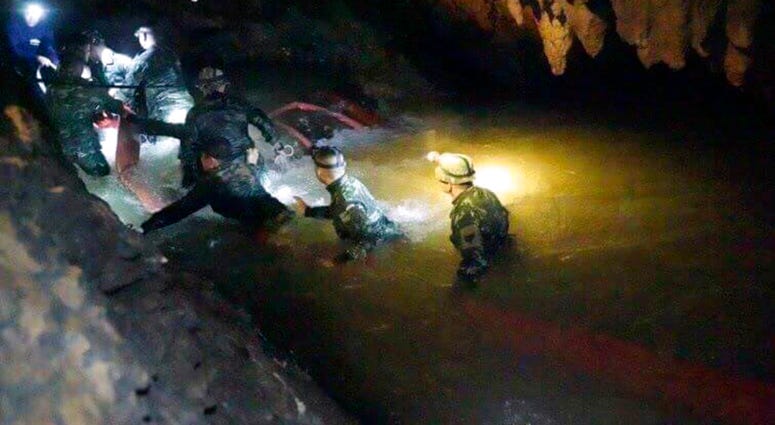 hai rescue teams walk inside cave complex where 12 boys and their soccer coach went missing, in Mae Sai, Chiang Rai province, in northern Thailand, Monday, July 2, 2018.