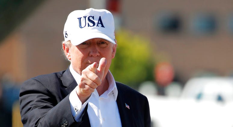 President Donald Trump points before boarding Air Force One at Morristown Municipal Airport, in Morristown, N.J., Sunday, July 8, 2018, en route to Washington from Trump National Golf Club in Bedminster, N.J. (AP Photo/Carolyn Kaster)