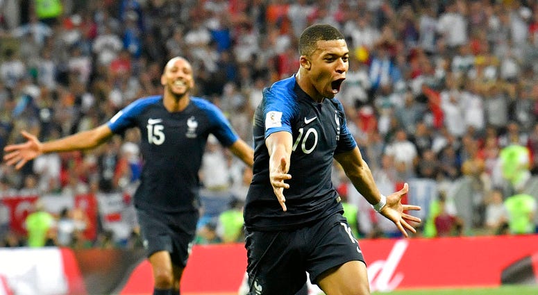 France's Kylian Mbappe, front, celebrates after scoring his side's fourth goal during the final match between France and Croatia at the 2018 soccer World Cup in the Luzhniki Stadium in Moscow, Russia, Sunday, July 15, 2018. (AP Photo/Martin Meissner)