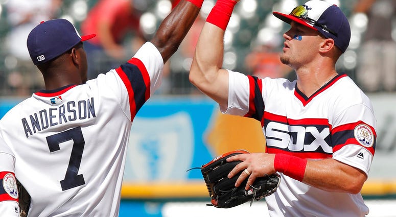 Chicago White Sox's Tim Anderson, left, and Adam Engel celebrate their team's win over the Kansas City Royals in a baseball game Sunday, July 15, 2018, in Chicago. (AP Photo/Jim Young)