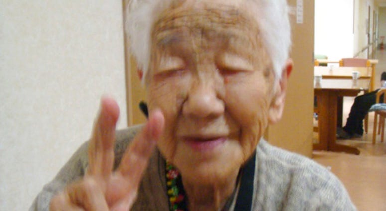 In this Jan. 2, 2018, photo provided by Goodtime Home 1, Kane Tanaka flashes a peace sign during her 115th birthday celebration at her nursing home in Fukuoka, southwestern Japan