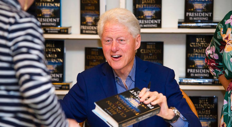 President Bill Clinton holds a copy of "The President is Missing" at Book Revue, in Huntington, NY. The book, co-written with James Patterson, has more than 1 million sales in North America.