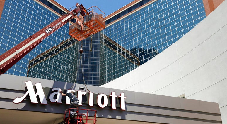 In this Tuesday, April 30, 2013, file photo, a man works on a new Marriott sign in front of the former Peabody Hotel in Little Rock, Ark. Marriott says the information of up to 500 million guests at its Starwood hotels has been compromised. It said Friday In this Tuesday, April 30, 2013, file photo, a man works on a new Marriott sign in front of the former Peabody Hotel in Little Rock, Ark. Marriott says the information of up to 500 million guests at its Starwood hotels has been compromised. It said Friday