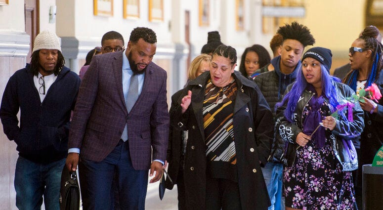 Rose family attorney, S. Lee Merritt, left, and Michelle Kenney, center, mother of Antwon Rose II, walk towards members of the media following the closing arguments.