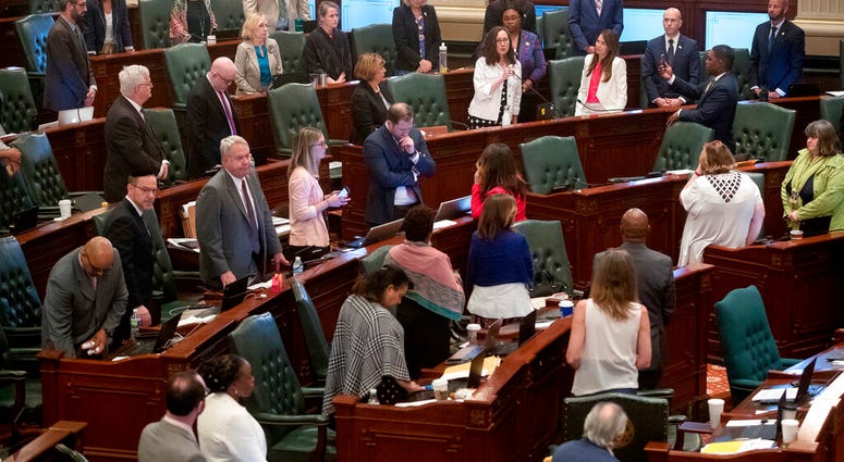 As her Democrat colleagues stand at their desks, Illinois state Rep. Kelly Cassidy, D-Chicago, makes a final plea for the Reproductive Health Act on the floor of the Illinois House chambers Tuesday, May 28, 2019, in Springfield, Ill. As her Democrat colleagues stand at their desks, Illinois state Rep. Kelly Cassidy, D-Chicago, makes a final plea for the Reproductive Health Act on the floor of the Illinois House chambers Tuesday, May 28, 2019, in Springfield, Ill.